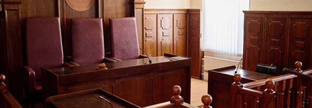 Empty BC Court of Appeal courtroom with three judges' chairs and dark wood panelling, representing the appellate process in British Columbia.